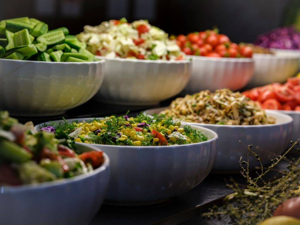 Colorful bowls of fresh vegetables and fruit for 5 A Day portions