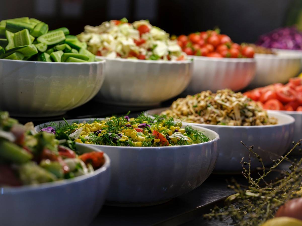 Colorful bowls of fresh vegetables and fruit for 5 A Day portions