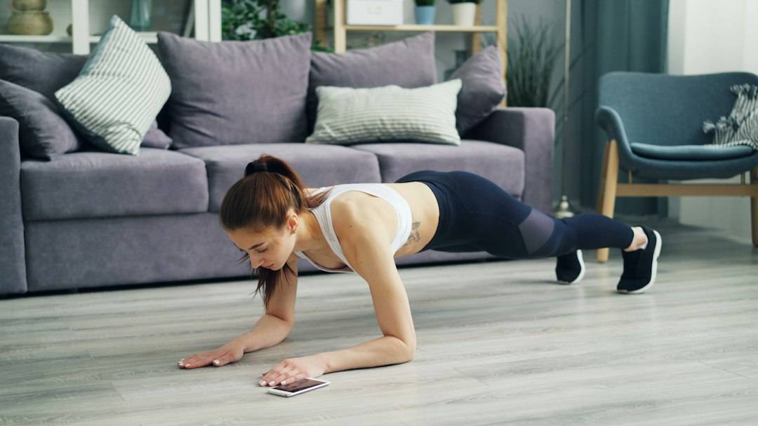 Adult completing a beginner strength workout at home