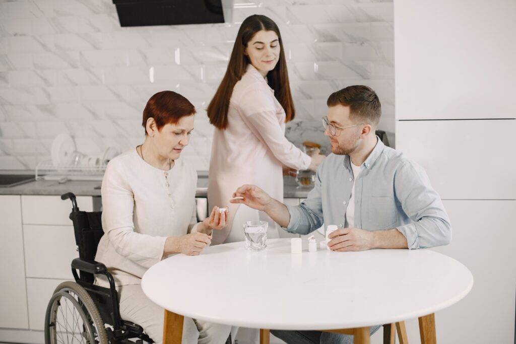 Family members supporting an older woman at home with everyday care