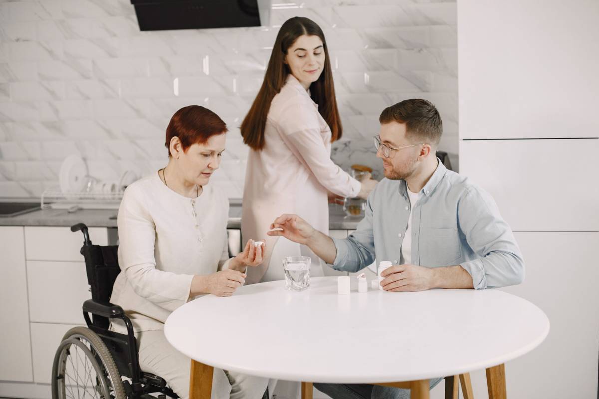 Family members supporting an older woman at home with everyday care
