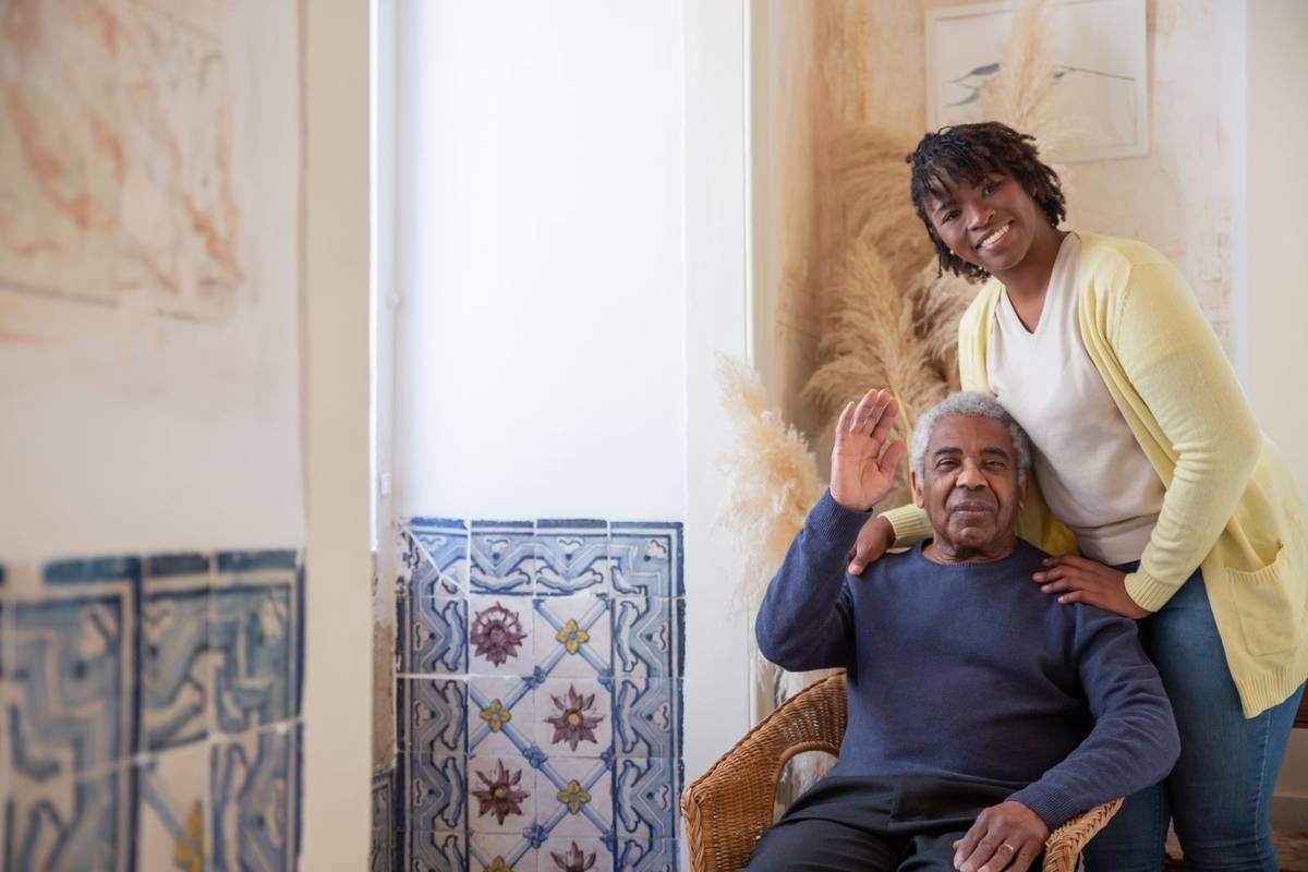 Adult daughter spending time with her older father at home