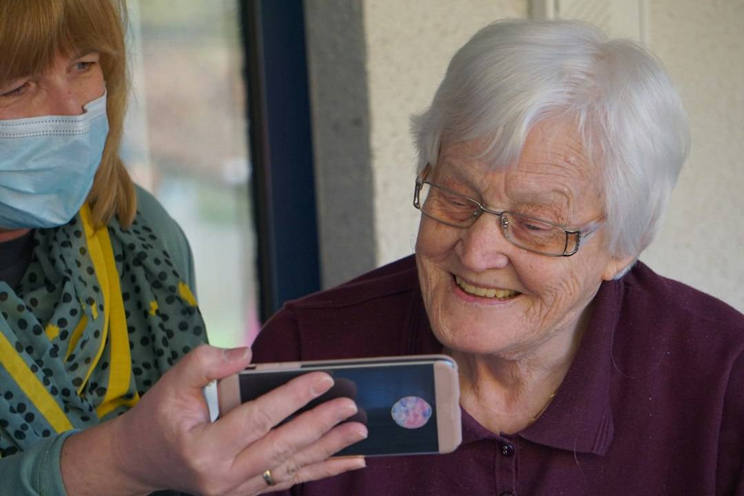 Older adult at home discussing support needs with family