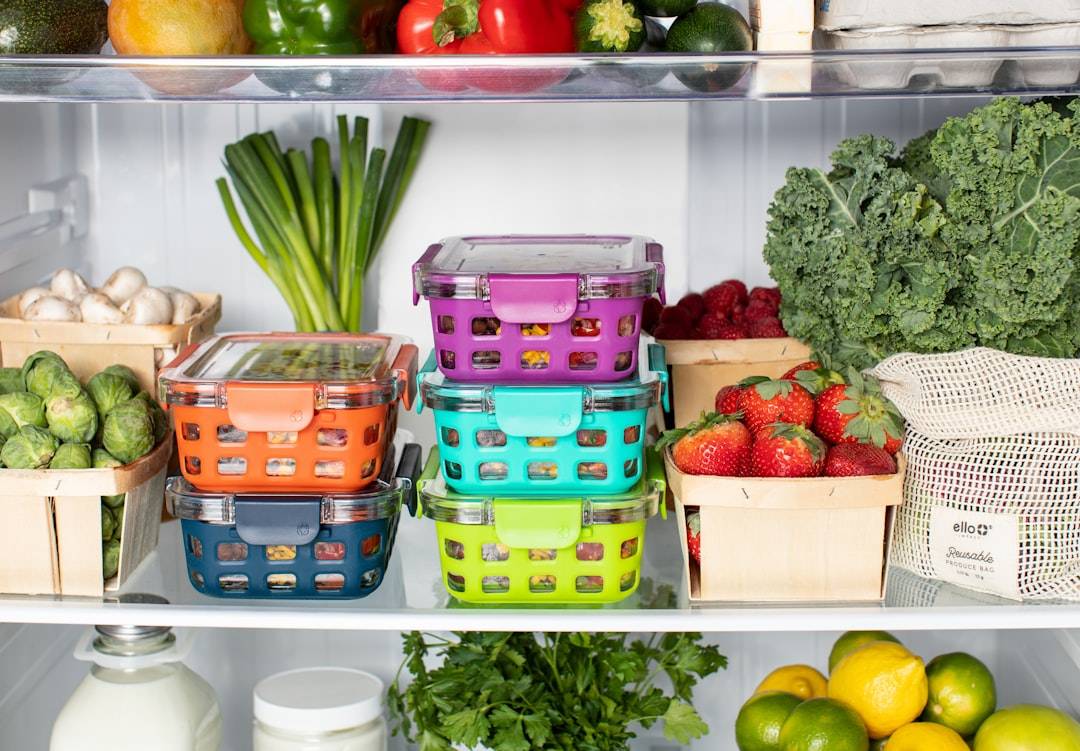 Organised refrigerator with food containers and fresh produce