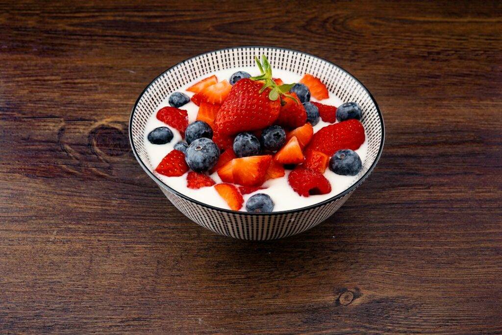 Plain yoghurt served with fresh berries and fruit