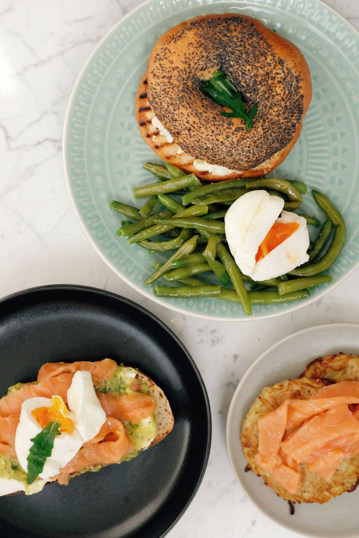 Breakfast spread with eggs, salmon, bread and avocado