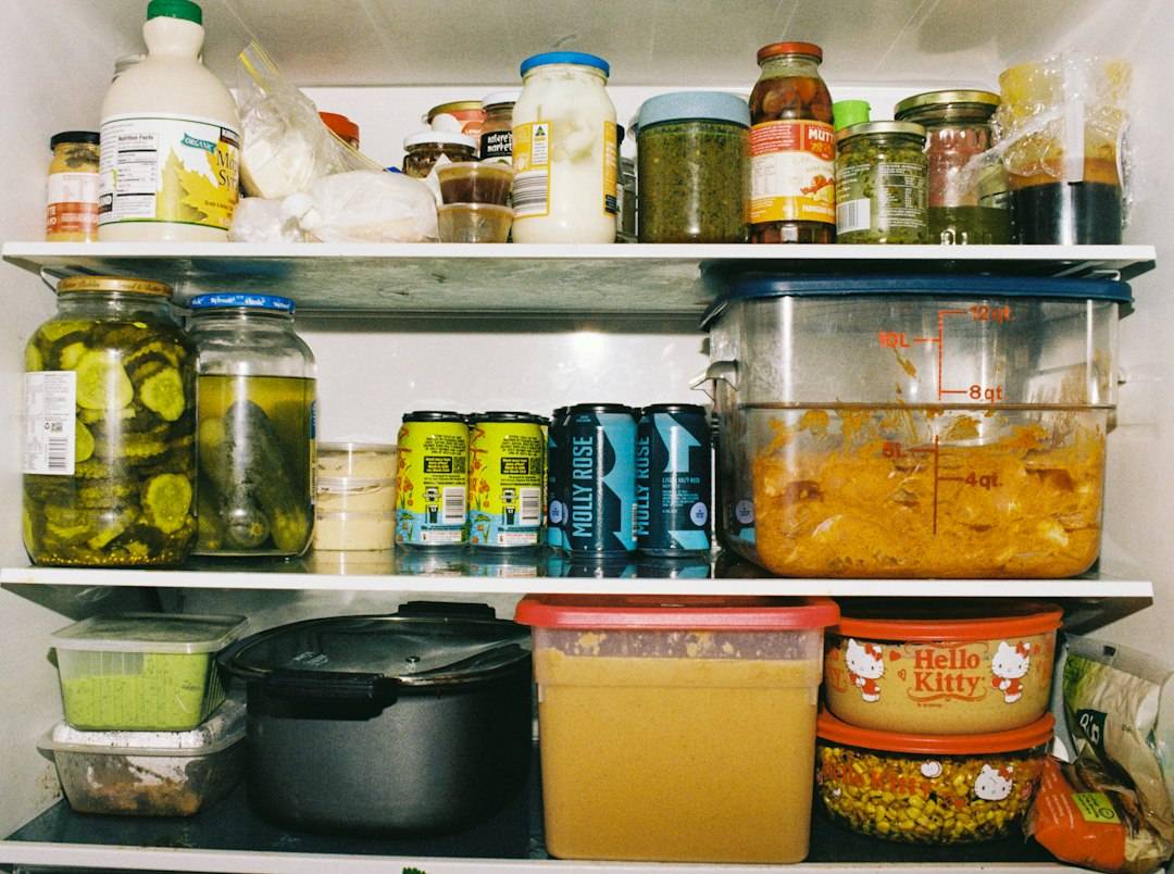Refrigerator shelves containing labelled food containers and leftovers