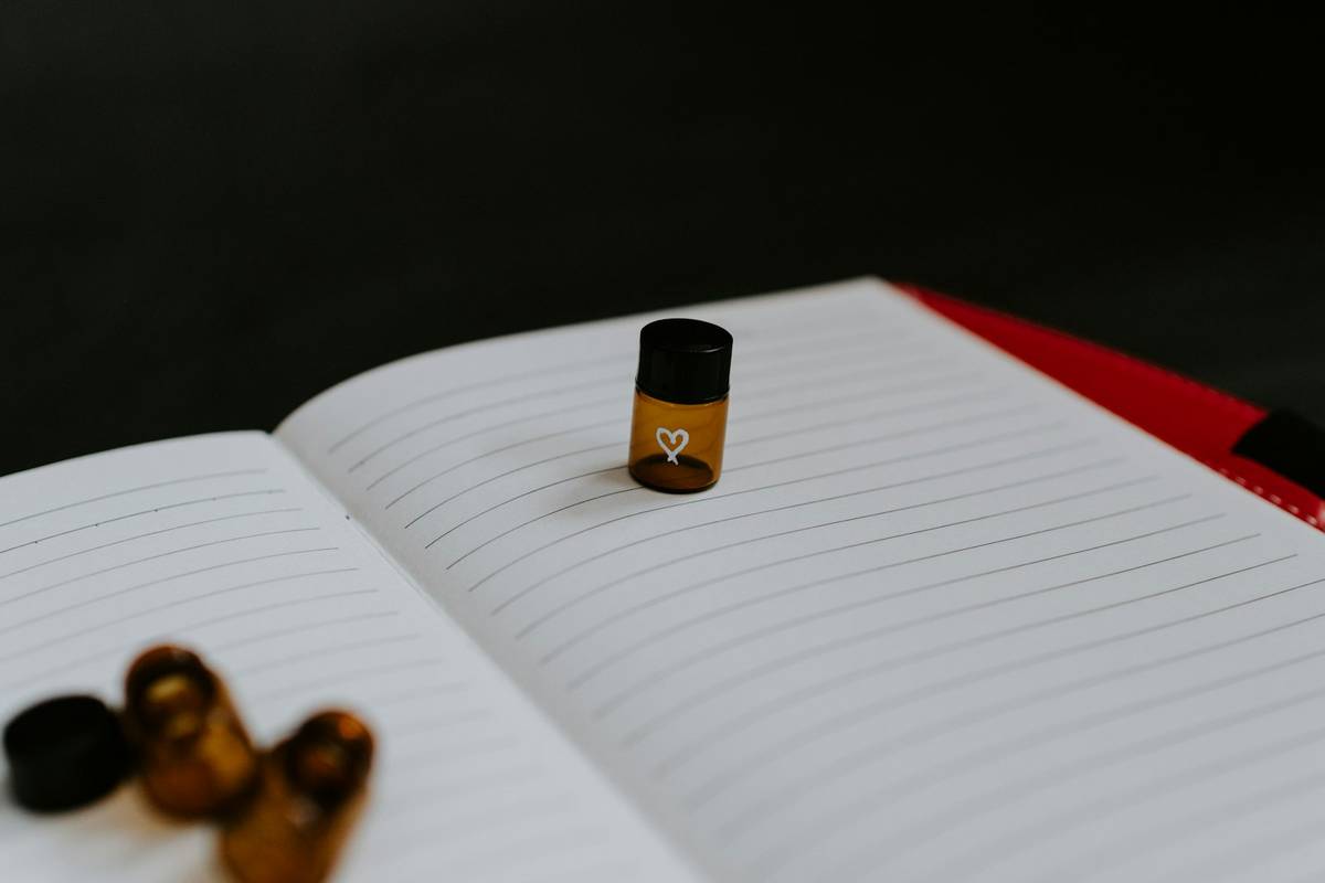 Medicine bottle resting on lined paper used for health notes