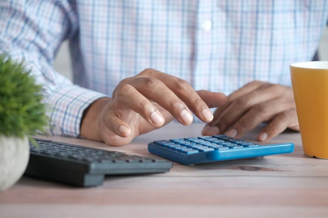 Person using a calculator to work through household income and care charges