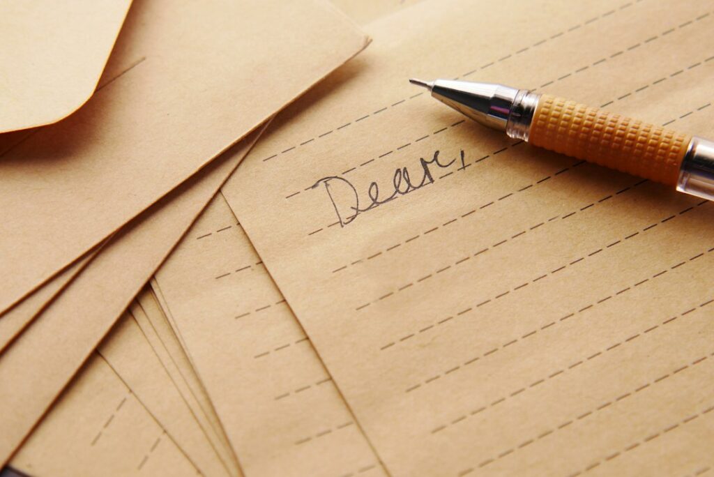 Pen and medical paperwork representing a referral letter and health records