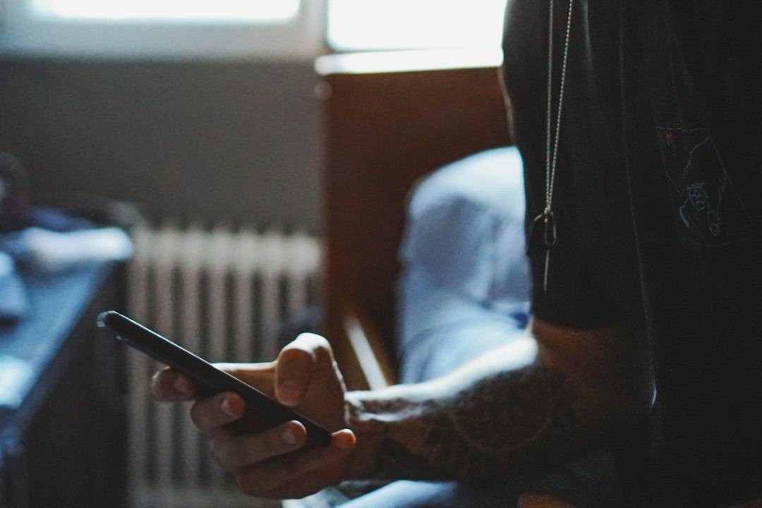 Person checking a healthcare text message on a smartphone
