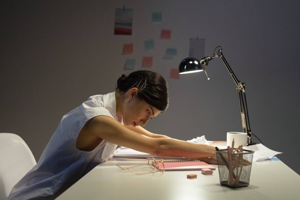 Office worker stretching forward at a desk