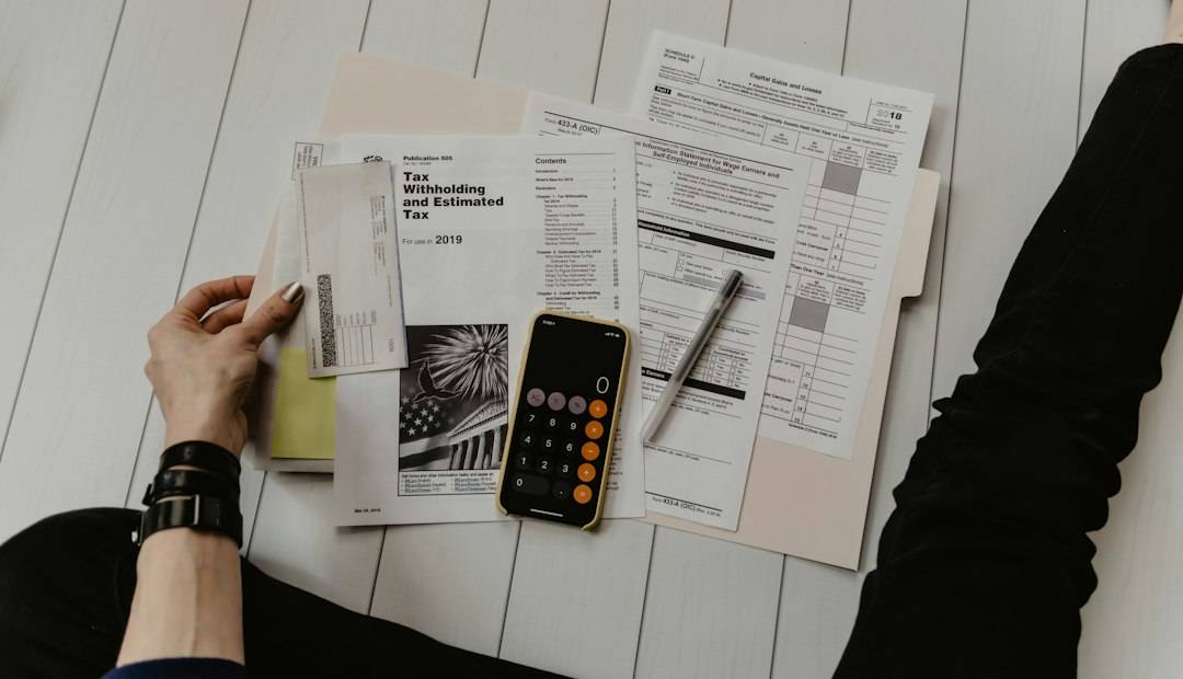 Calculator and paperwork used to compare a social care personal budget with real costs