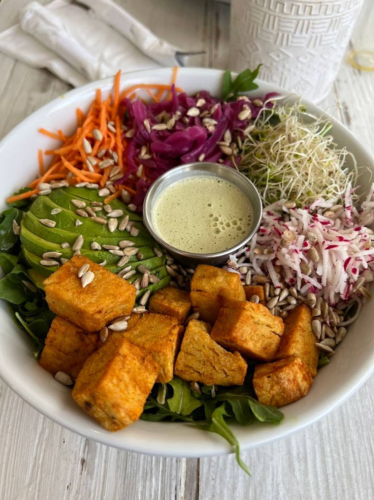 Plant-based bowl with tofu, avocado, vegetables and seeds