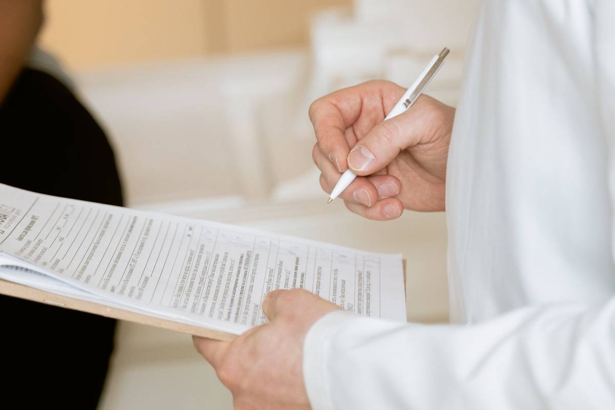 Healthcare professional reviewing patient referral paperwork and records