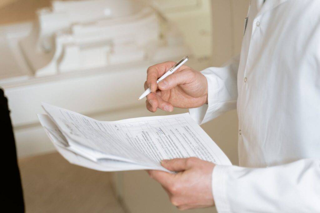 Doctor reviewing medical documents during referral triage