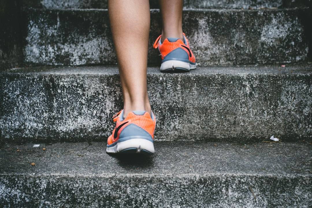 Person walking up concrete stairs during a beginner stair-walking session