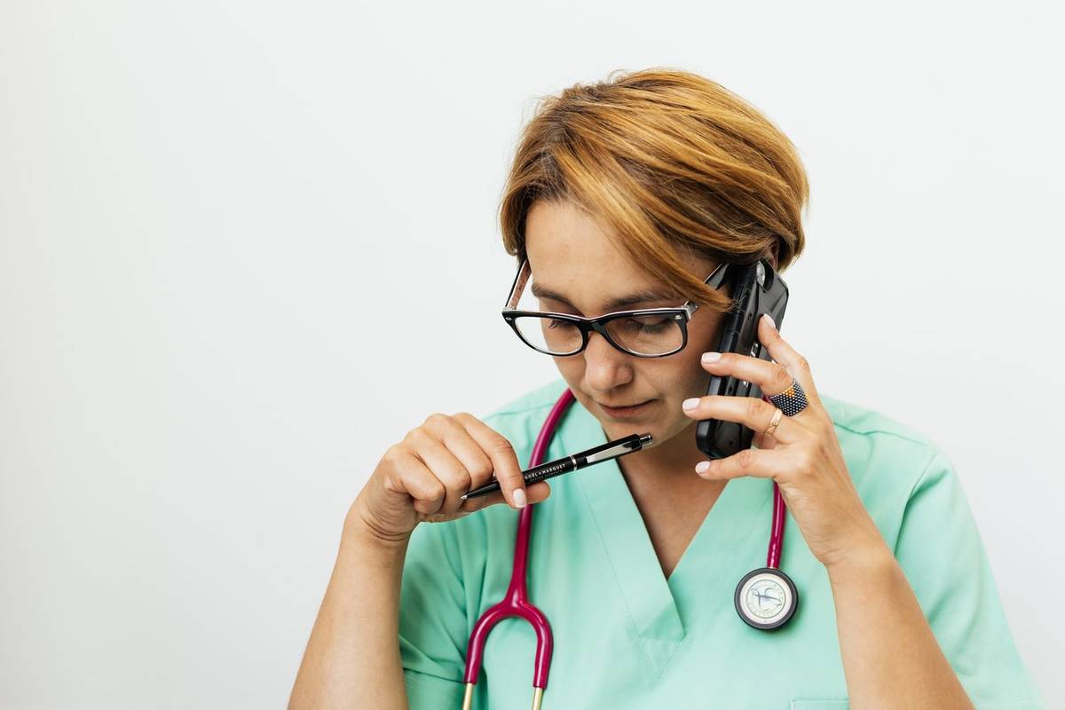 Doctor speaking on a phone during a medical consultation