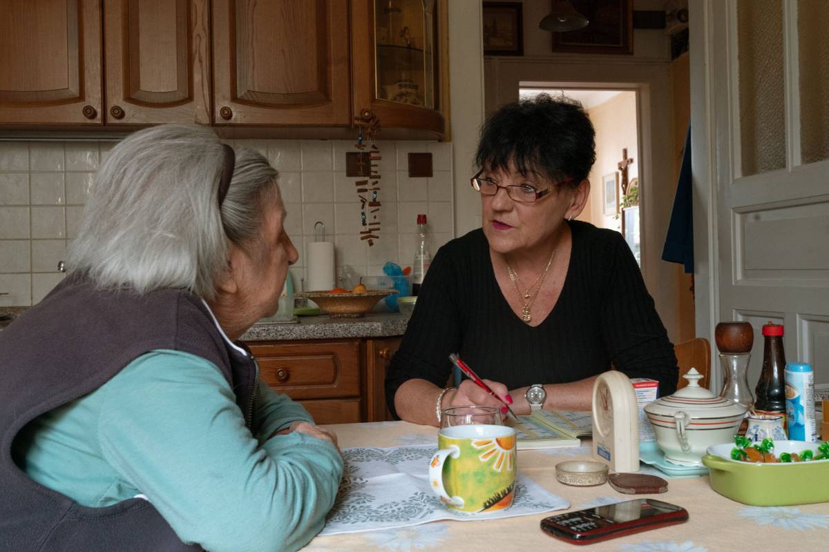 Family carer discussing care arrangements with an older adult at home
