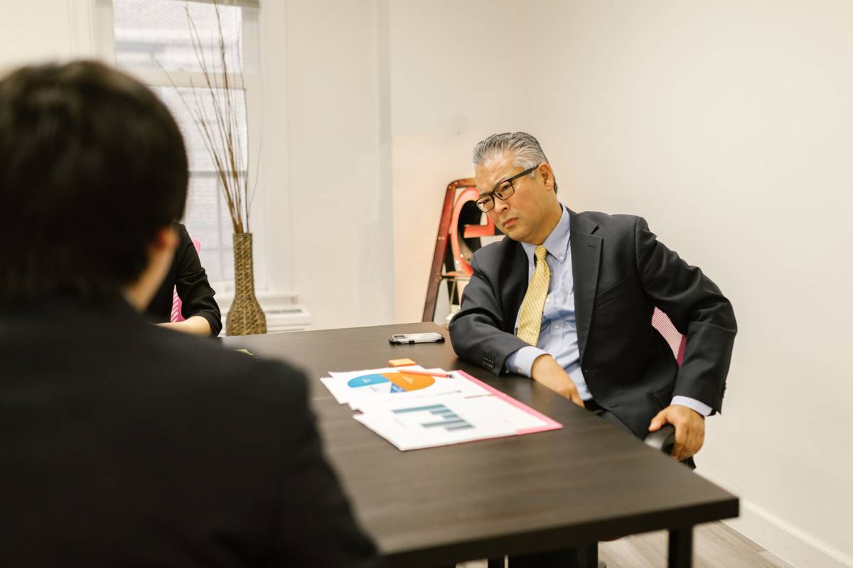 Two colleagues discussing workplace health and practical adjustments in an office