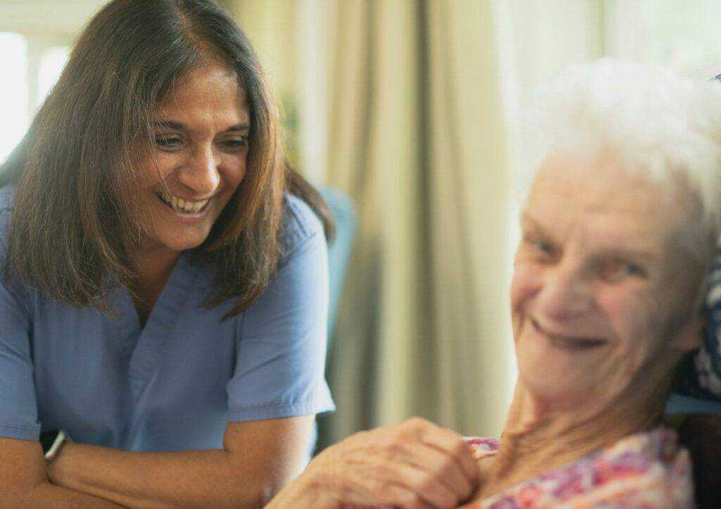 Nurse talking with an older woman in a care setting