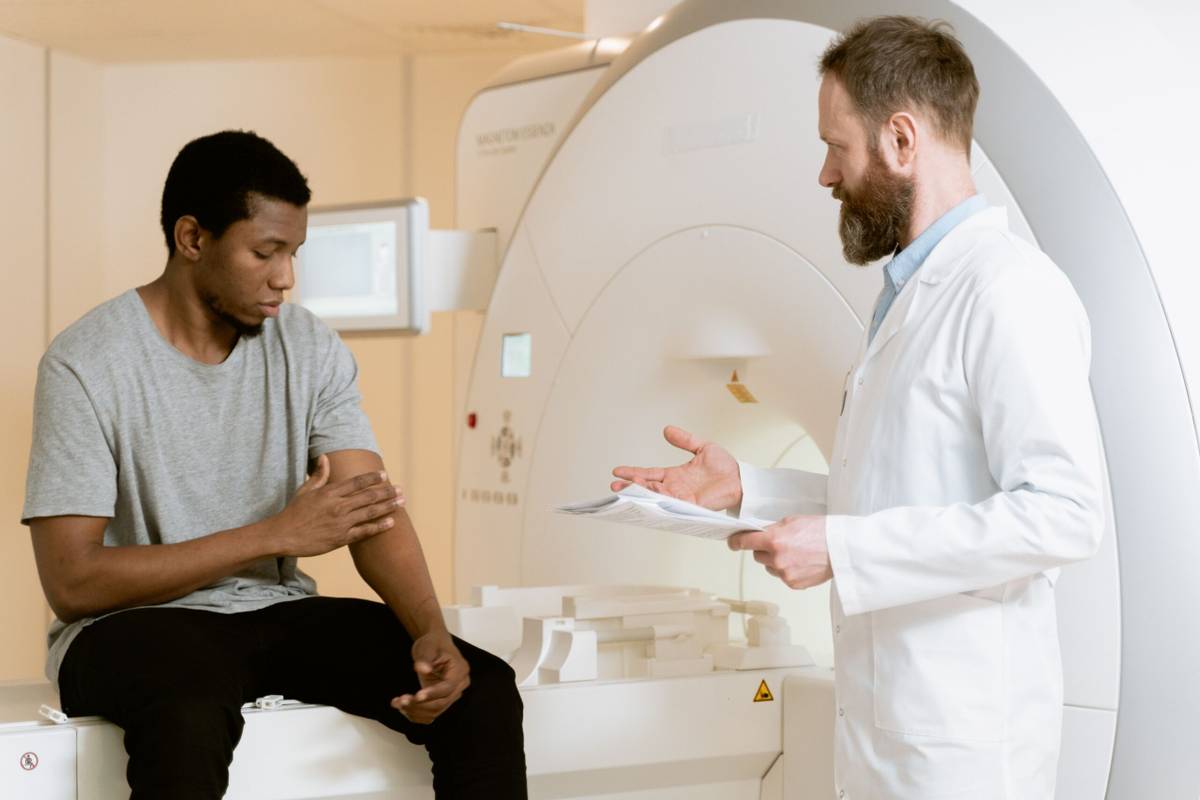 Doctor discussing hospital treatment with a patient during specialist care