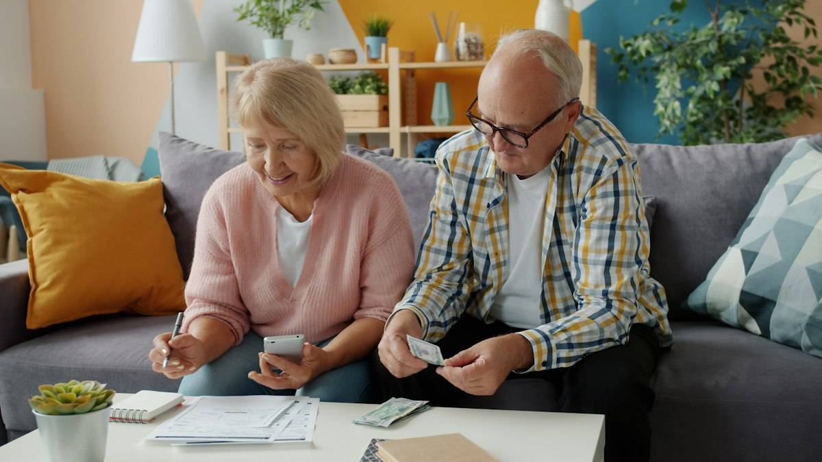 Older couple reviewing financial paperwork together at home